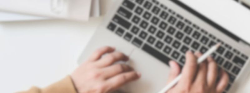 Working on a laptop, doing work, featured on XCL Website