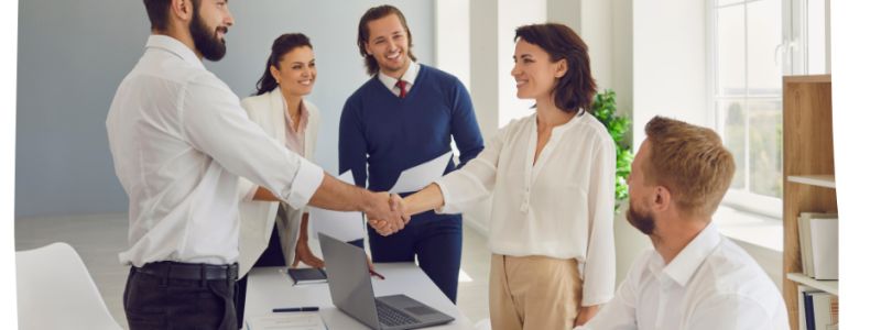 Office setting. Manager and candidate shaking hands, interview process complete. Featured on XCL website